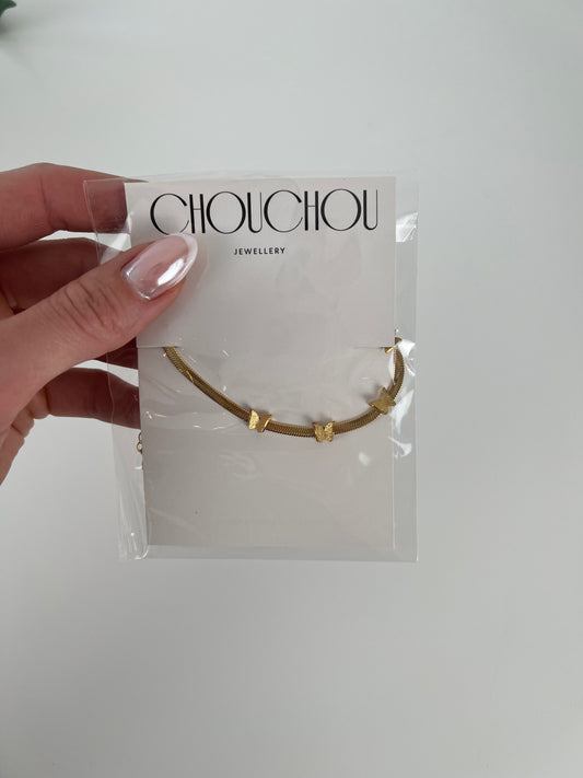 Platte armband met vlinders goud